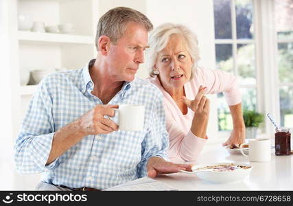 Retired couple arguing at breakfast