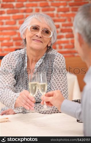 retired couple celebrating anniversary at restaurant