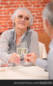 retired couple celebrating anniversary at restaurant