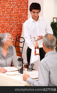 retired couple in restaurant celebrating anniversary