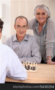retired couple playing chess