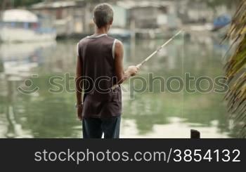 Retired elderly people and leisure activity, old man fishing near the sea. Dolly shot