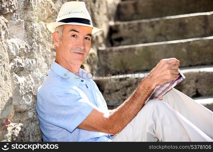 Retired man reading his guidebook