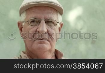 Retired people, portrait of three sad old men looking at camera on bench in hospice