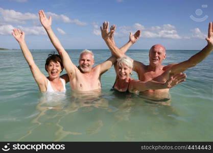 Retired people swimming in the ocean