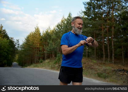 Retired sportsman using modern digital gadget for tracking health indicator during running training. Retired sportsman using modern digital gadget during running