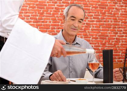 retiree at restaurant with sommelier