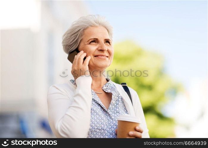 retirement, communication and old people concept - happy senior woman drinking coffee and calling on smartphone in summer city. senior woman calling on smartphone in city