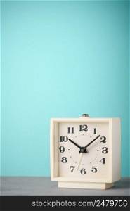 Retro alarm clock with blue background vertical copy space