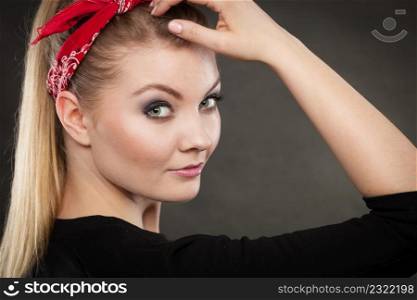 Retro and vintage style. Old fashion. Portrait of lovely pretty young woman in pin up hairstyle with red handkerchief on head.. Portrait of retro pin up girl in red handkerchief.
