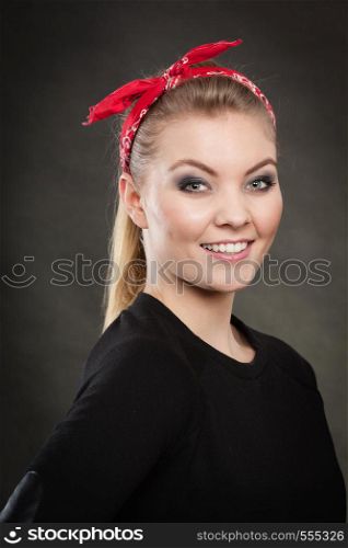 Retro and vintage style. Old fashion. Portrait of lovely pretty young woman in pin up hairstyle with red handkerchief on head.. Portrait of retro pin up girl in red handkerchief.