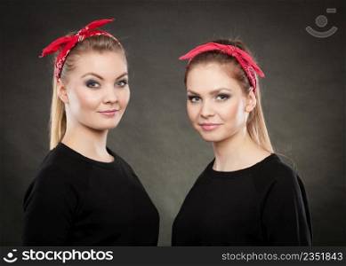 Retro and vintage style. Old fashion. Portrait of lovely pretty young women in pin up hairstyle with red handkerchief on head.. Portrait of retro pin up girls in red handkerchief.