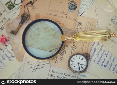 retro  background of old papers with vintage finding glass, retro toned. antiques vintage background