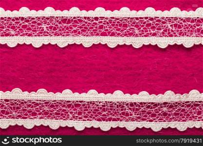 Retro border for invitations celebration. Vintage white lace over pink textile background.