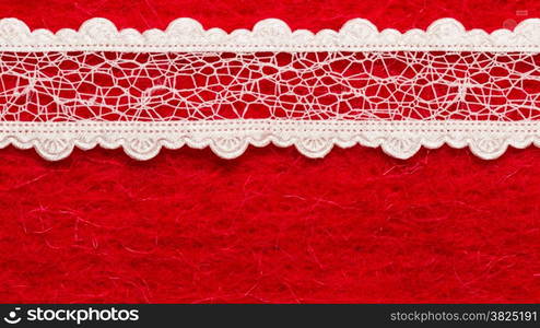 Retro border for invitations celebration. Vintage white lace over red textile background.