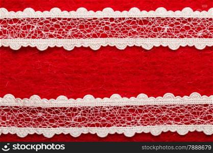 Retro border for invitations celebration. Vintage white lace over red textile background.