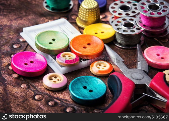 Retro buttons and threads. Domestic collection of colourful sewing retro buttons and threads