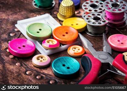 Retro buttons and threads. Domestic collection of colourful sewing retro buttons and threads