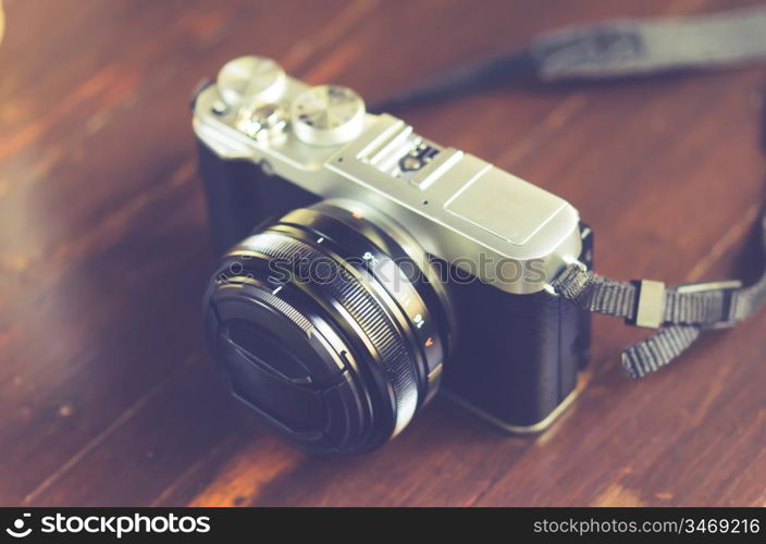 Retro camera on old wooden table background