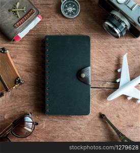 Retro camera with toy plane, passport, travel items and dairy on old wooden background, Travel concept. Retro camera with toy plane, passport, travel items and dairy, Travel concept