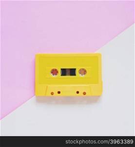 Retro cassette tape on pastel color background, minimal style
