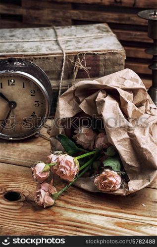 retro composition with bouquet of roses and staromodniot hours
