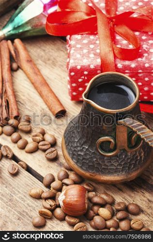 Retro composition with coffee in cezve and a gift for Christmas. Christmas coffe and toy