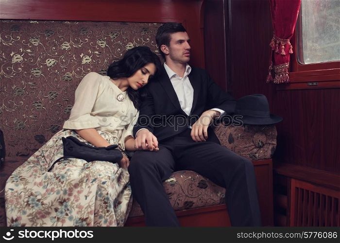 retro fashionable couple at vintage train car