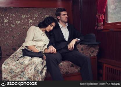 retro fashionable couple at vintage train car