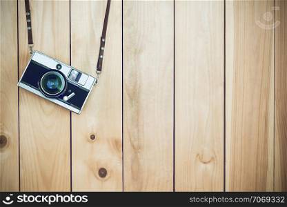 Retro film cameras holding on wood background with free copy space, vintage background.