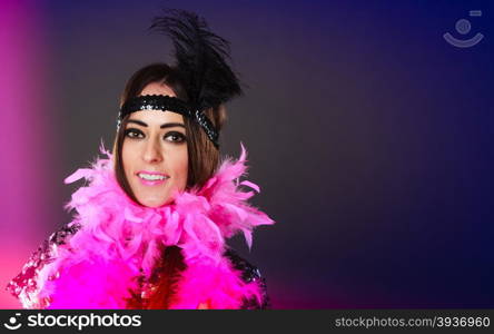 Retro flapper woman on carnival time. Young female pink plume and black feather on head.