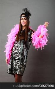 Retro flapper woman on carnival time. Young female pink plume black feather on head and sequin glossy evening dress