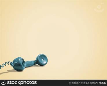 Retro green rotary phone handset on a bright vintage yellow background with copy space and room for text