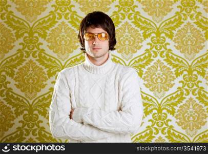 retro hip young man with vintage glasses and winter turtleneck sweater on wallpaper