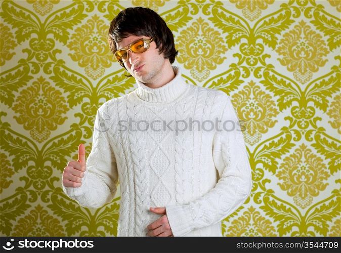 retro hip young man with vintage glasses and winter turtleneck sweater on wallpaper