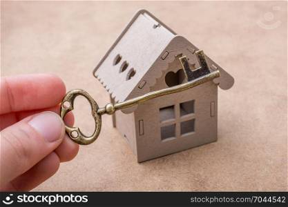 Retro key and a Model house on a canvas background