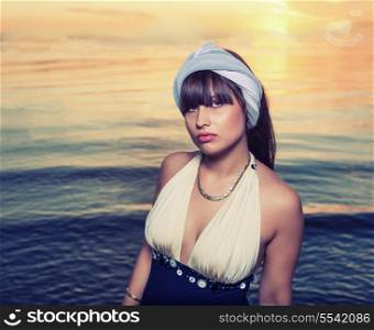 Retro looking image of pretty female near water colorized toned image