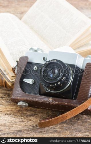 retro photo camera. retro photo camera with books on wooden background