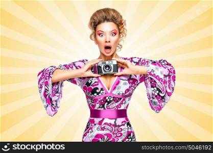 Retro photo of an amazed fashionable hippie homemaker, holding an old vintage photo camera with two hands and showing emotions on colorful abstract cartoon style background.