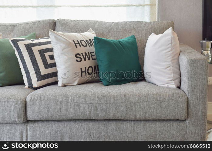 Retro pillows on the cozy grey sofa in the living room