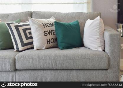 Retro pillows on the cozy grey sofa in the living room