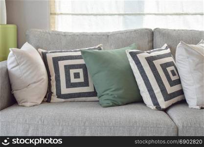 Retro pillows on the cozy grey sofa in the living room
