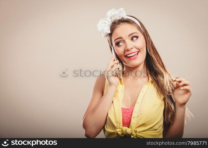 Retro pin up attractive girl talking on mobile phone. Woman with cellphone using technology.