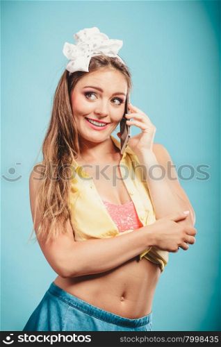 Retro pin up attractive girl talking on mobile phone. Woman with cellphone using technology.