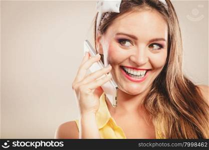 Retro pin up attractive girl talking on mobile phone. Woman with cellphone using technology.