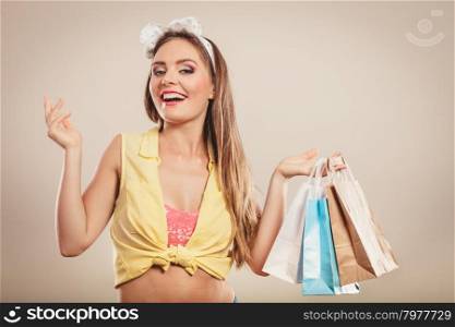 Retro pin up girl shopping. Retro pin up girl shopping. Woman holding paper bag. Having fun.