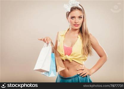 Retro pin up girl shopping. Retro pin up girl shopping. Woman holding paper bag.