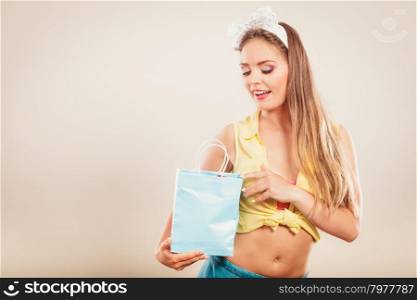 Retro pin up girl shopping. Retro pin up girl shopping. Woman loking into paper bag.