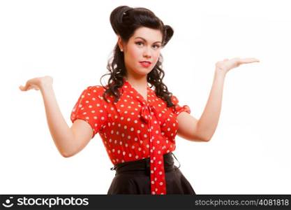 Retro pin-up girl shrugging her sholders. Young woman spreading arms or having blank copy space on her empty hands isolated on white. Studio shot. Old-fashioned style.