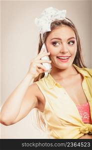 Retro pin up girl talking on mobile phone. Woman with cellphone using technology.